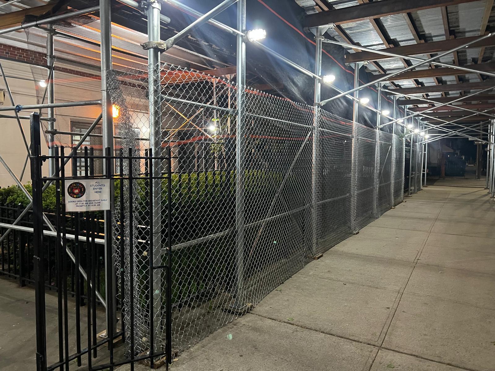 NYC building with sidewalk shed and scaffolding